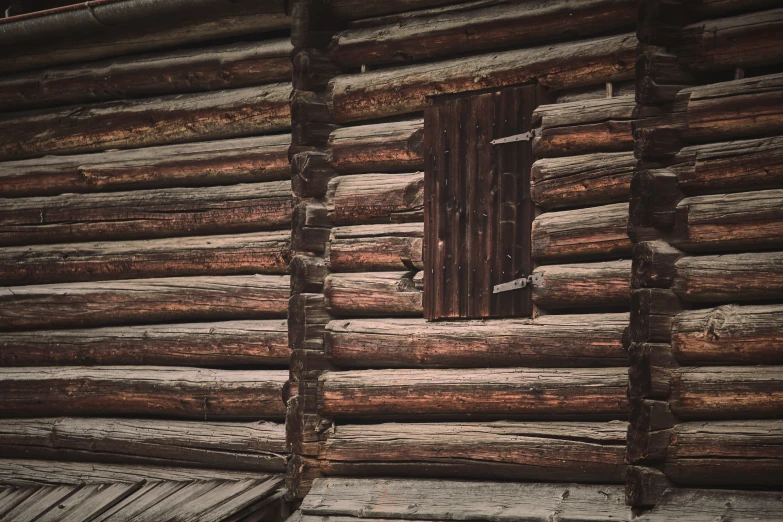 the view from inside an old log house