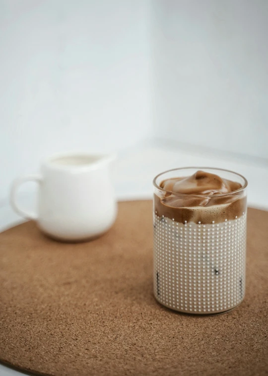 this beverage is in a glass mug on top of the mat