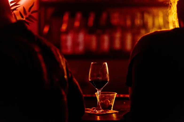 a couple of people sitting down at a bar