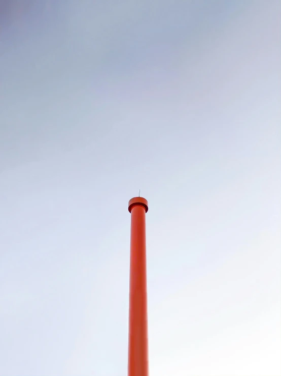 a orange pipe sitting on top of an industrial area