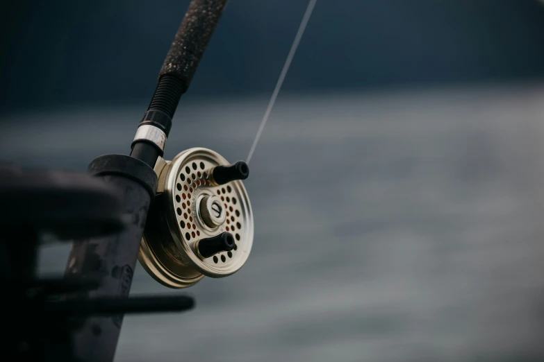 closeup of fishing spinning from reel, with hook, and string