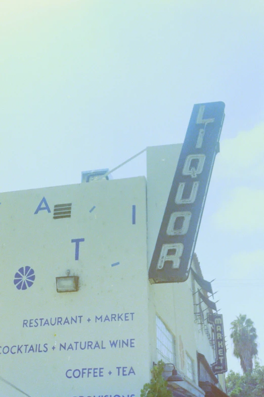 an old sign is displayed next to a giant store