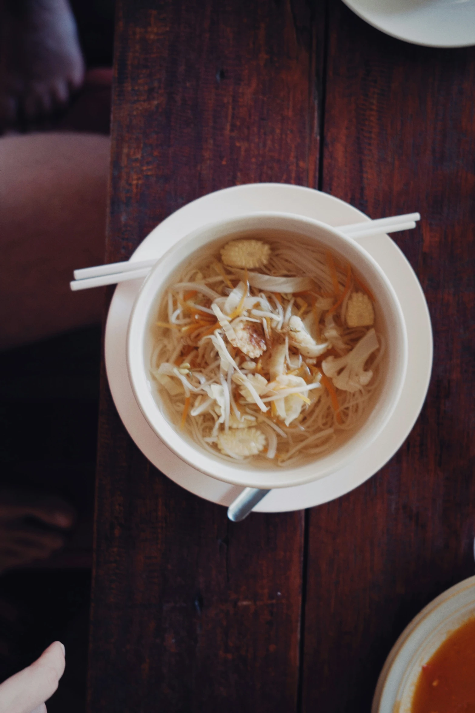 a bowl of noodles and noodles with a cup of chili