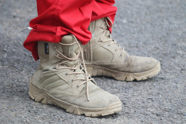 a person wearing tan military boots in the street