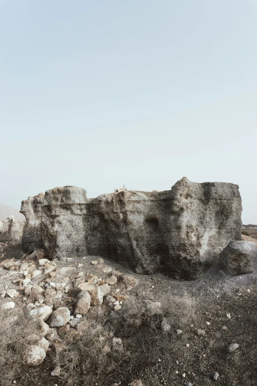 a very large rock covered in dirt and rocks