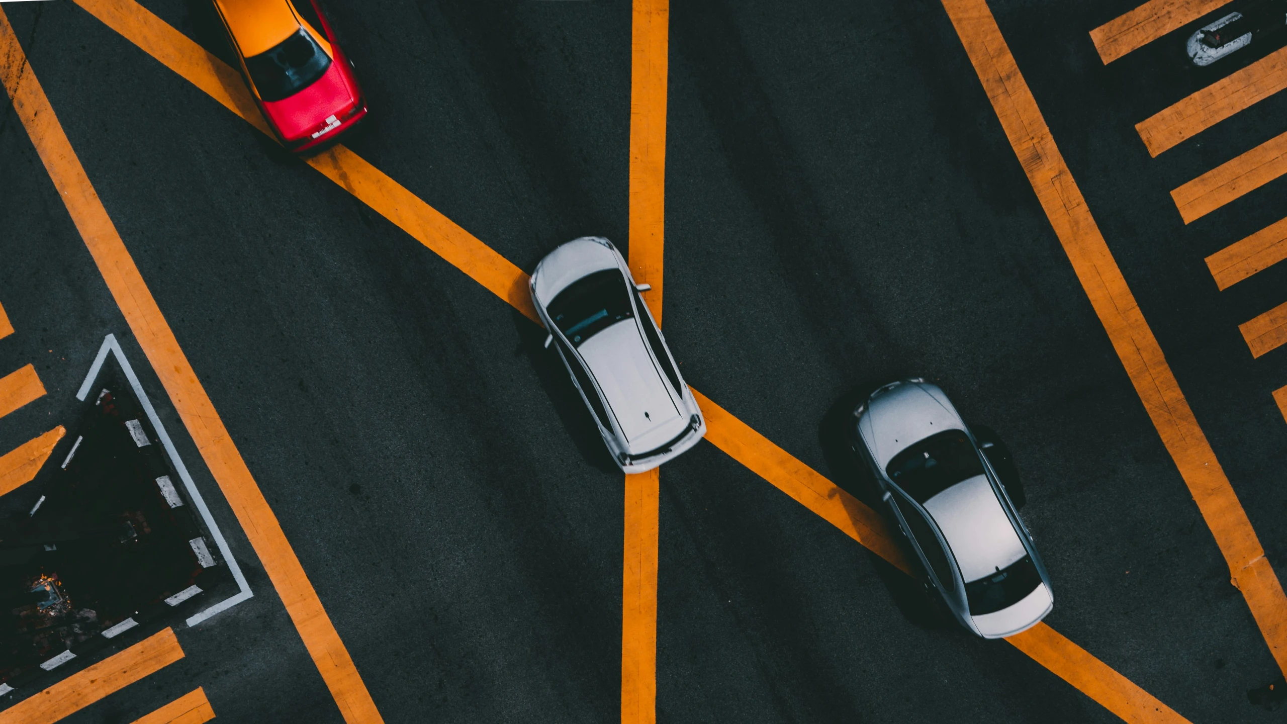 two cars are in a cross walk between two ze crossing