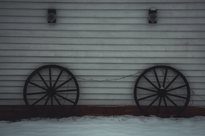 there are two old wagon wheels hanging on the wall