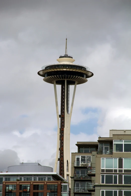 the space needle is surrounded by large apartment buildings