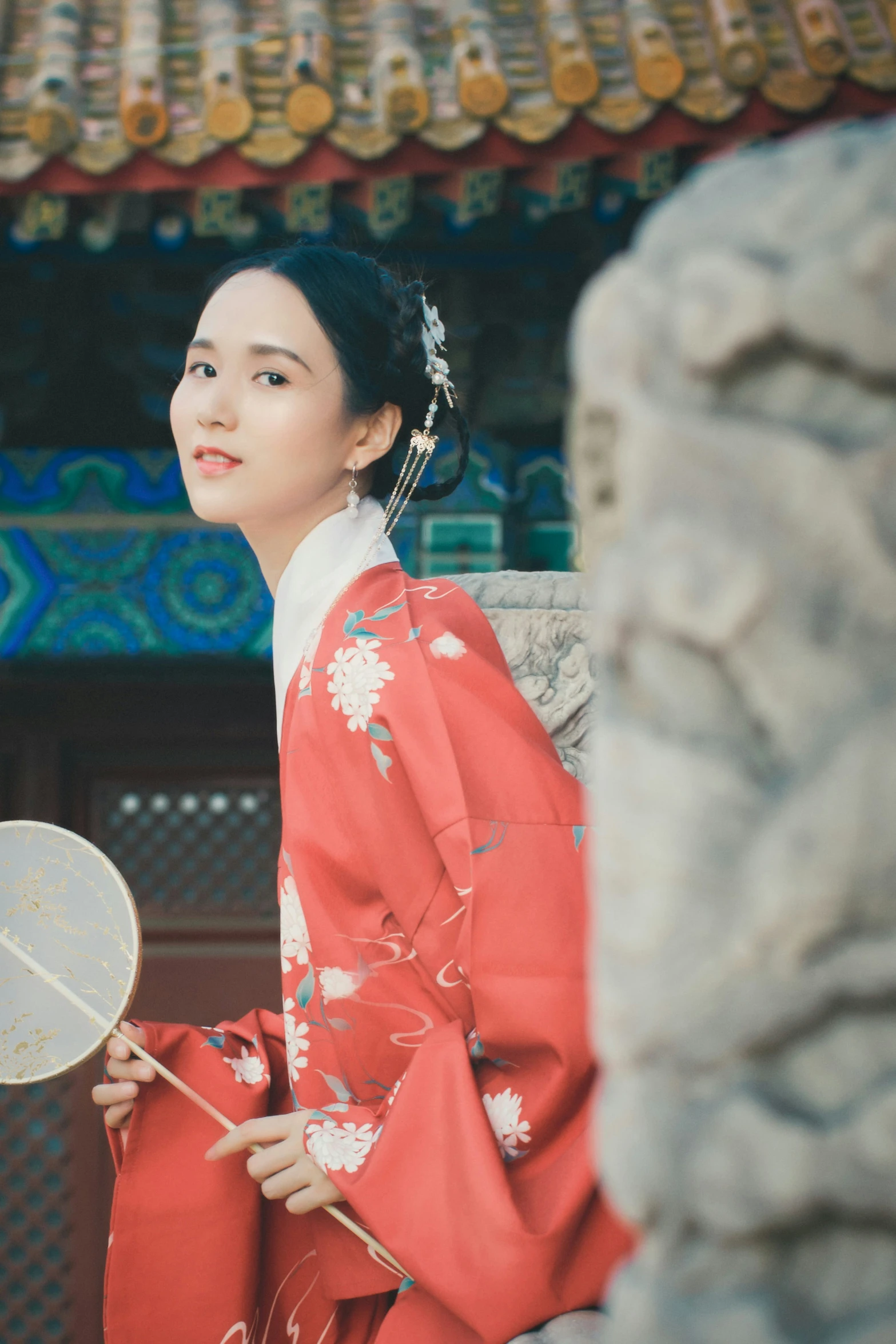 the asian woman is wearing a traditional red dress