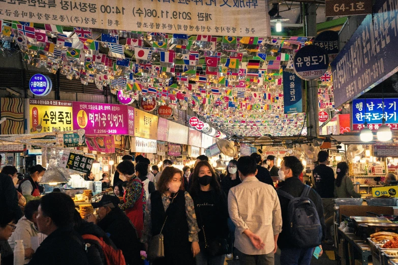 there are many people walking in a market