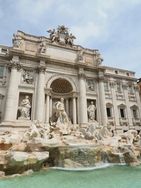 there is a fountain with two statues on the front