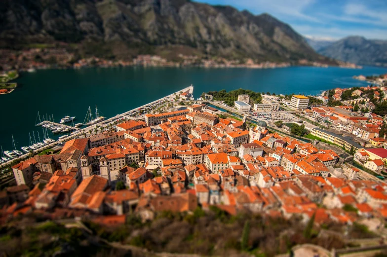 a po of the city with many red rooftops in the foreground