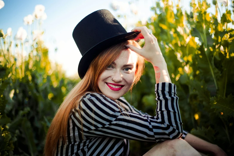 a woman wearing a hat while posing for a po