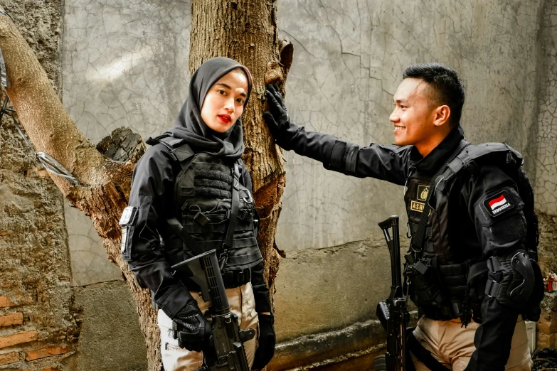 the young man in uniform has his hand on the shoulder of the young woman