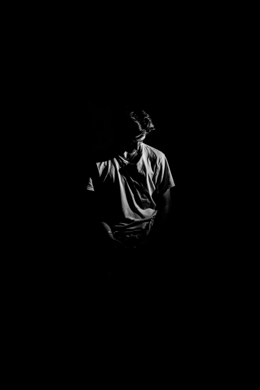 a black and white po of a man in the dark