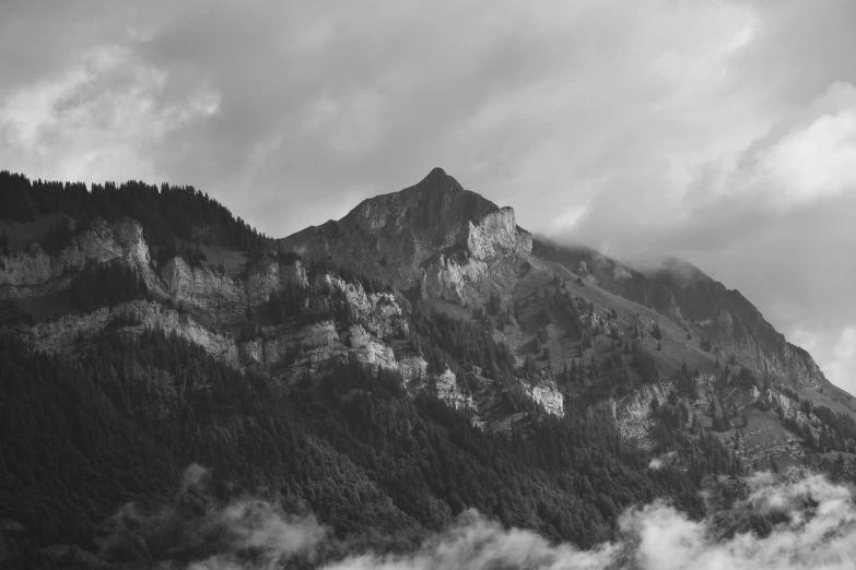 a cloudy view of a mountain with the sky over the top