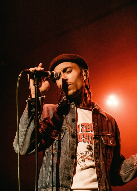 a man standing next to a microphone on stage