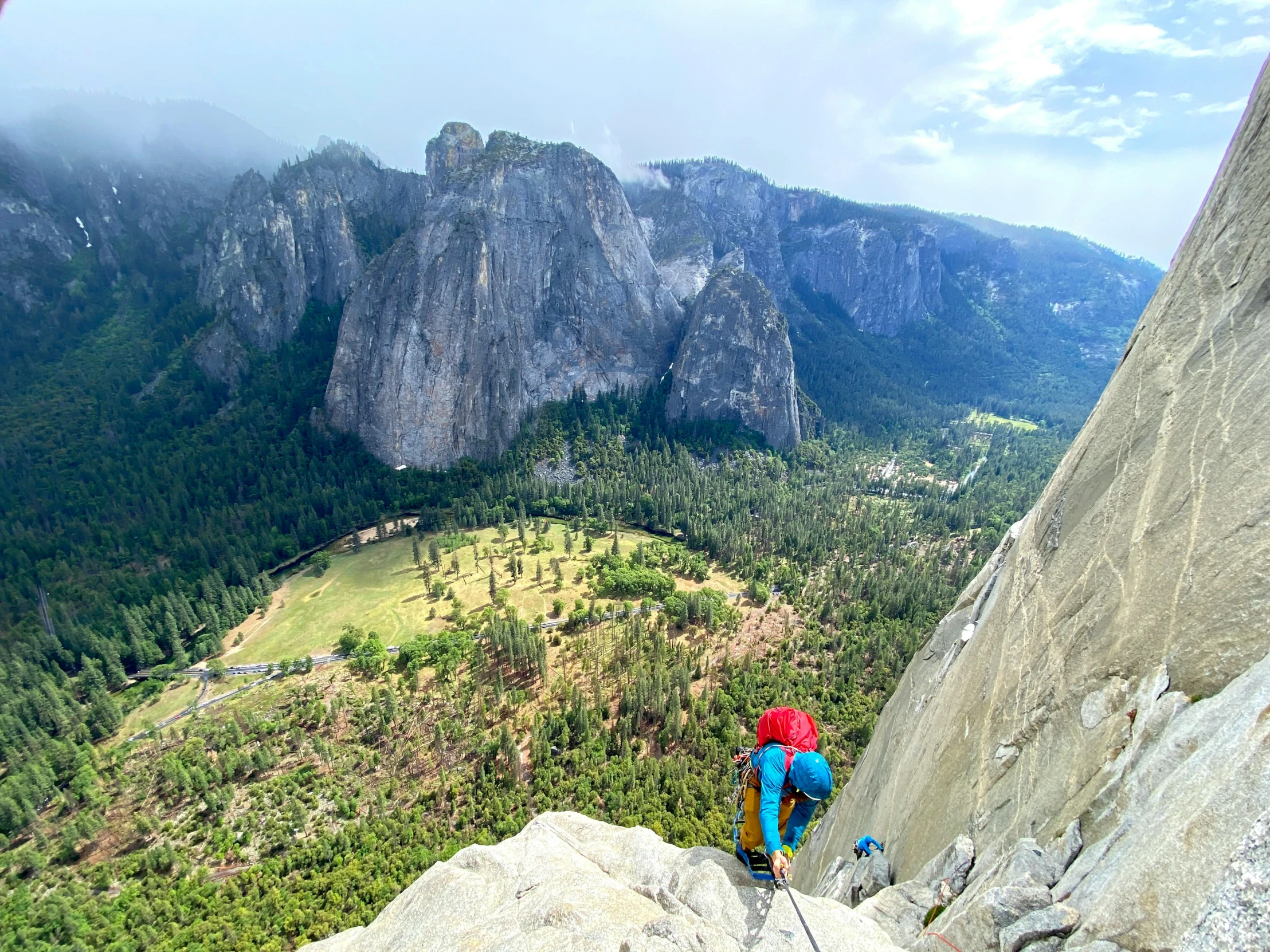 a man climbing up the side of a mountain