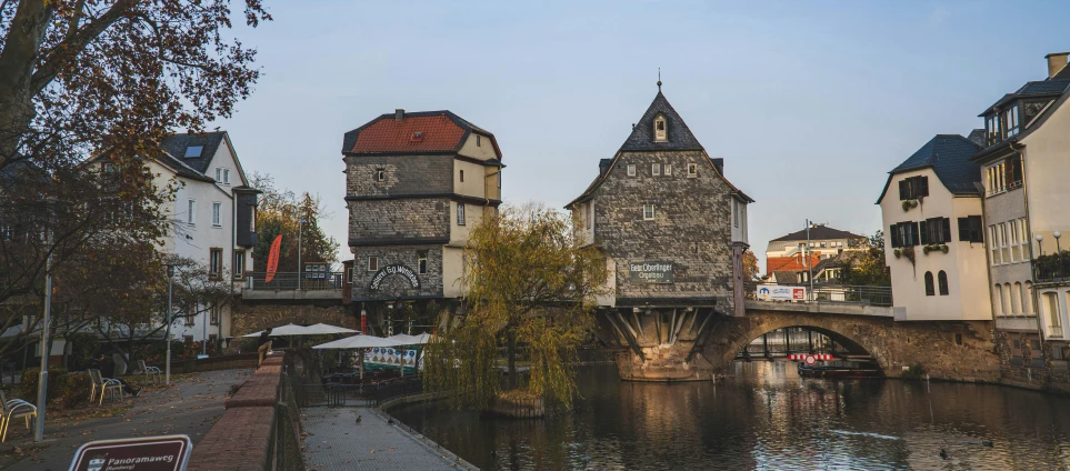 an old bridge in the city with many houses