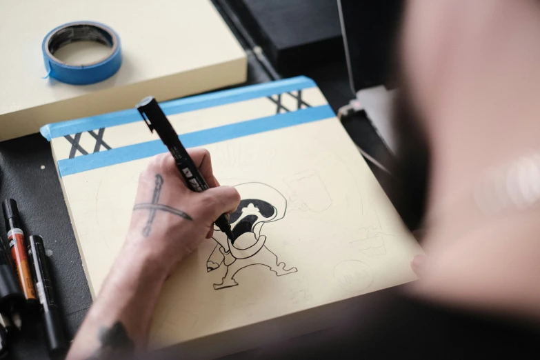 someone draws a drawing on a piece of paper