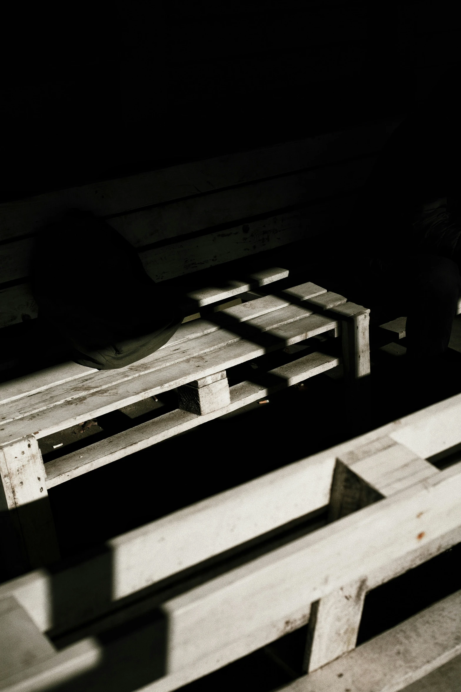 two wooden benches and one bench sitting on it