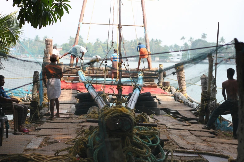 fishing nets sit on the wooden deck of a fishing boat