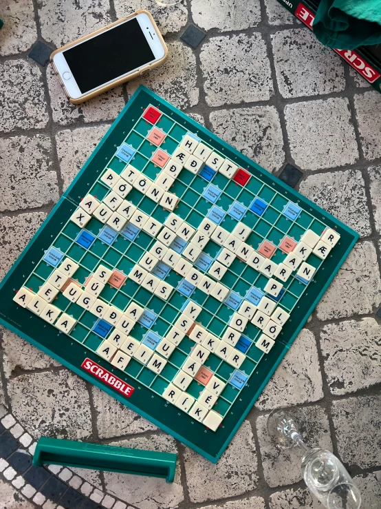 scrabble board with letters and numbers on a sidewalk