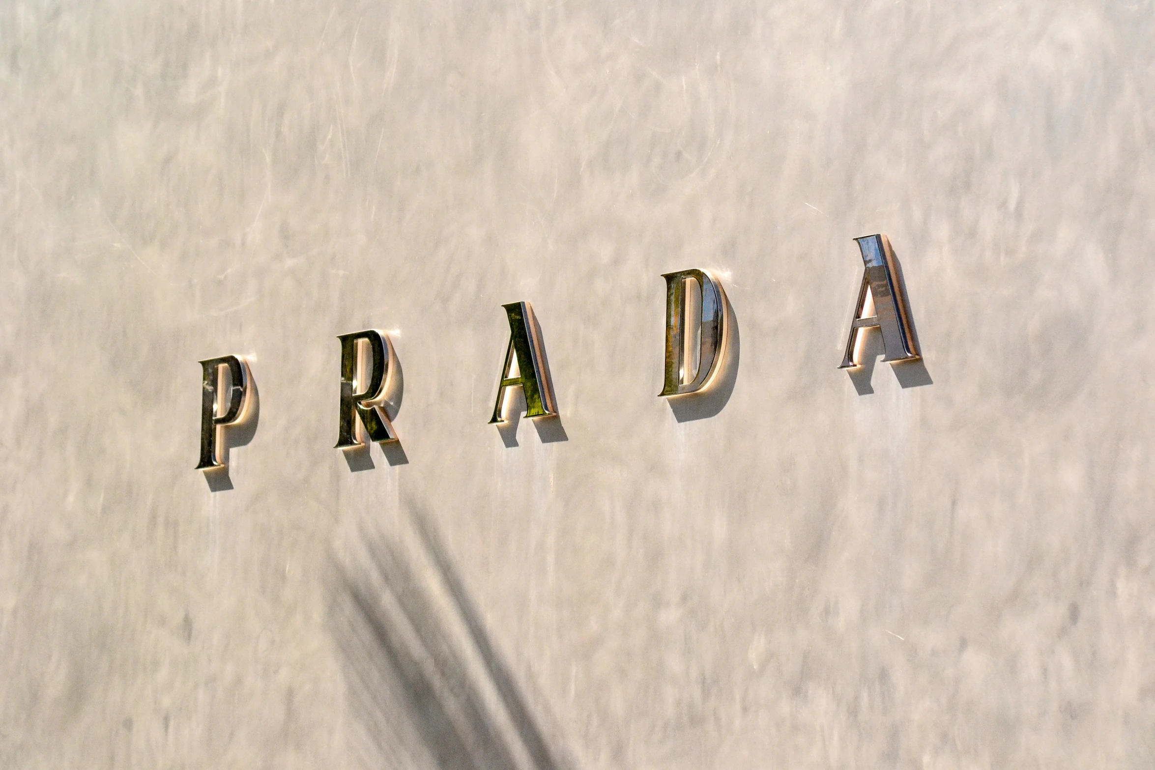 a close up of the word prada written in letters on a wall