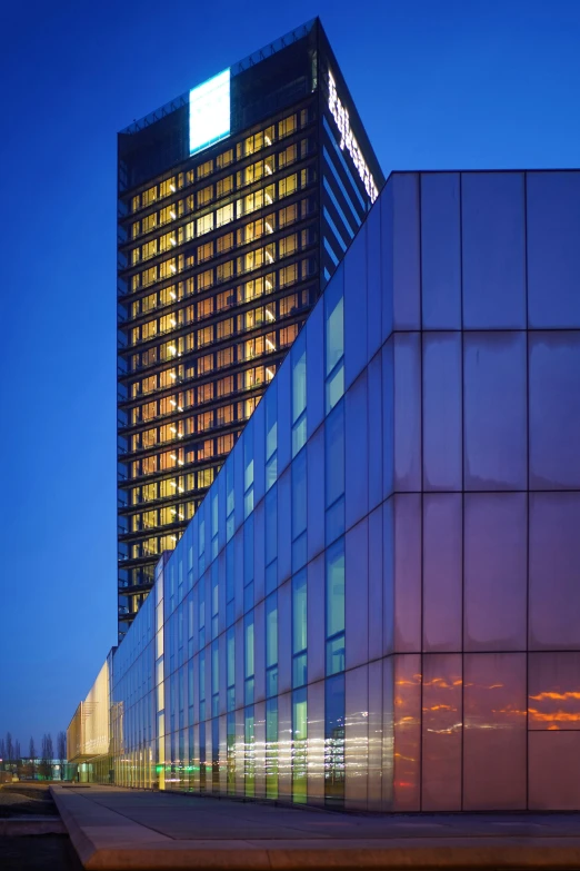 a tall glass building with a very long face