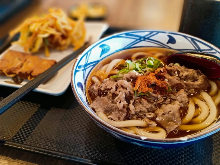 noodles with meat in sauce sitting on a table