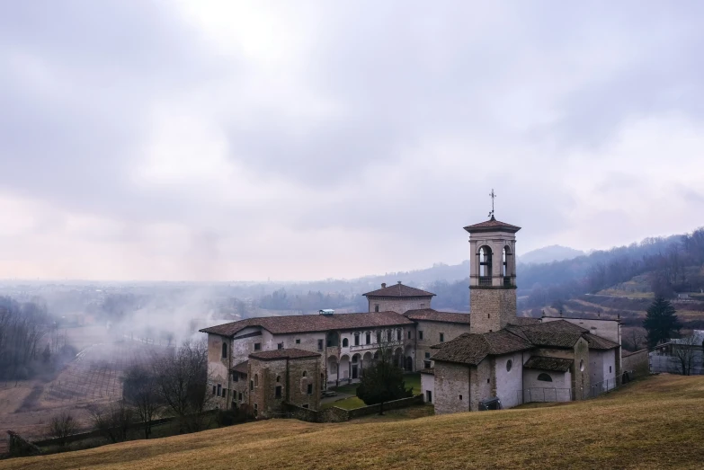 a lone church on top of a hill in italy