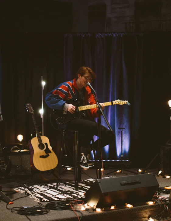 a person that is playing a guitar on stage