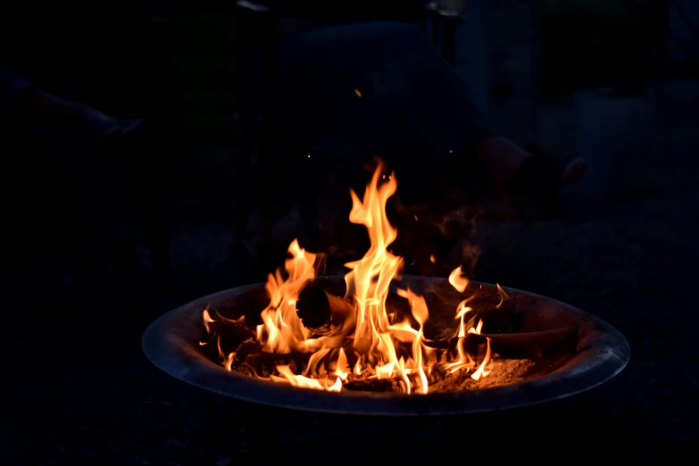 fire flames are lit in a fire pit