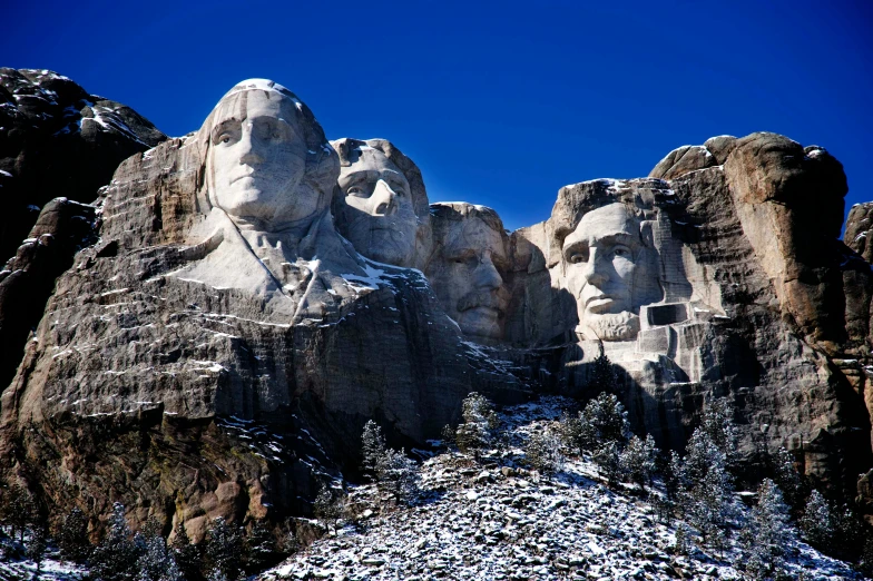 some rock presidents, face carved into them by snow