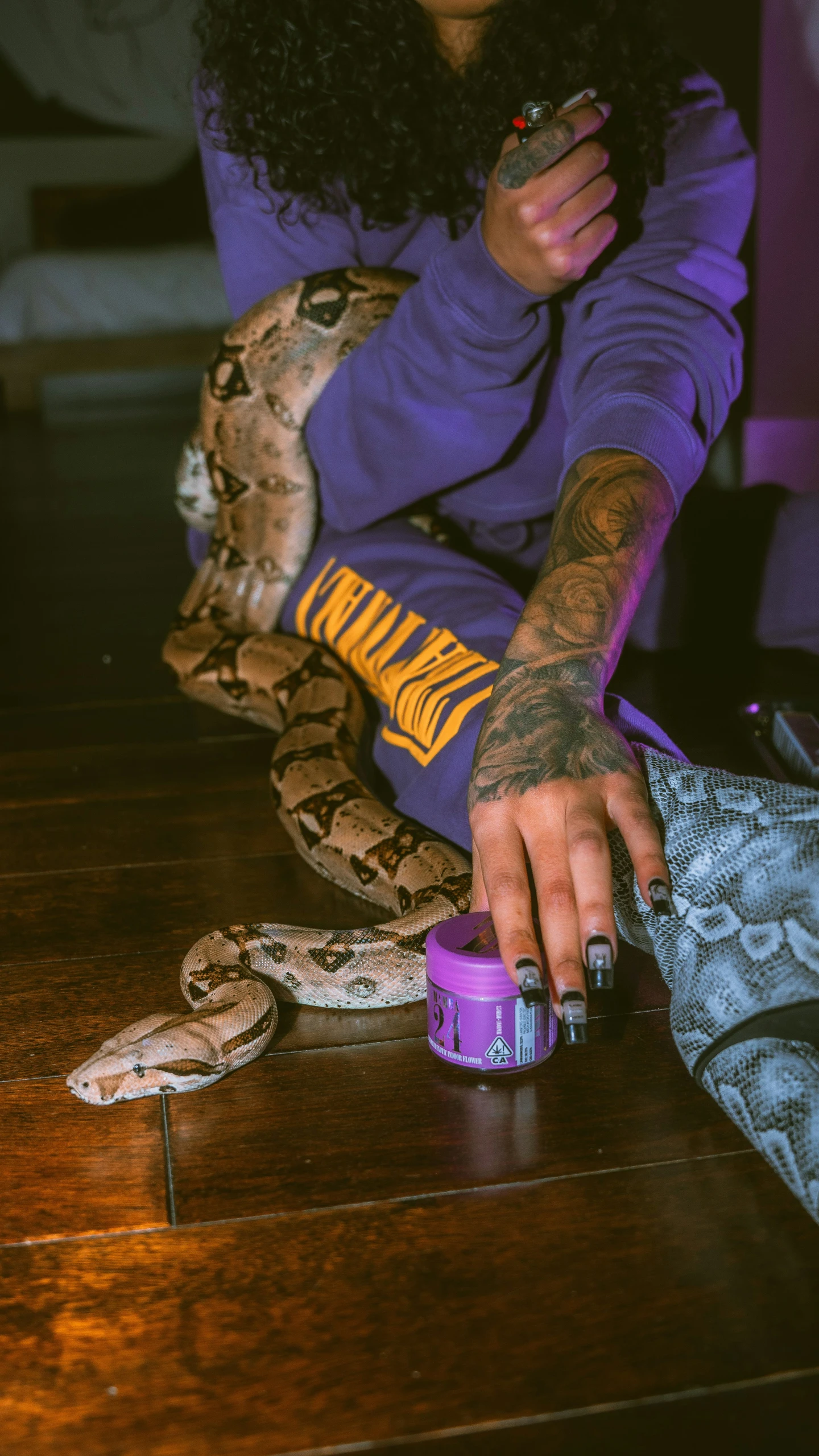 a woman in purple hoodie sitting on a table