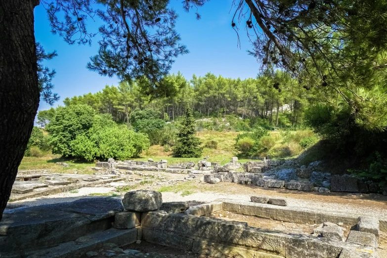 a stone structure with steps leading to trees