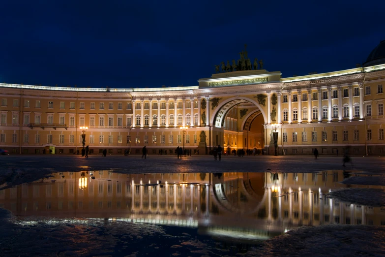 the palace with its beautiful clock tower lit up at night