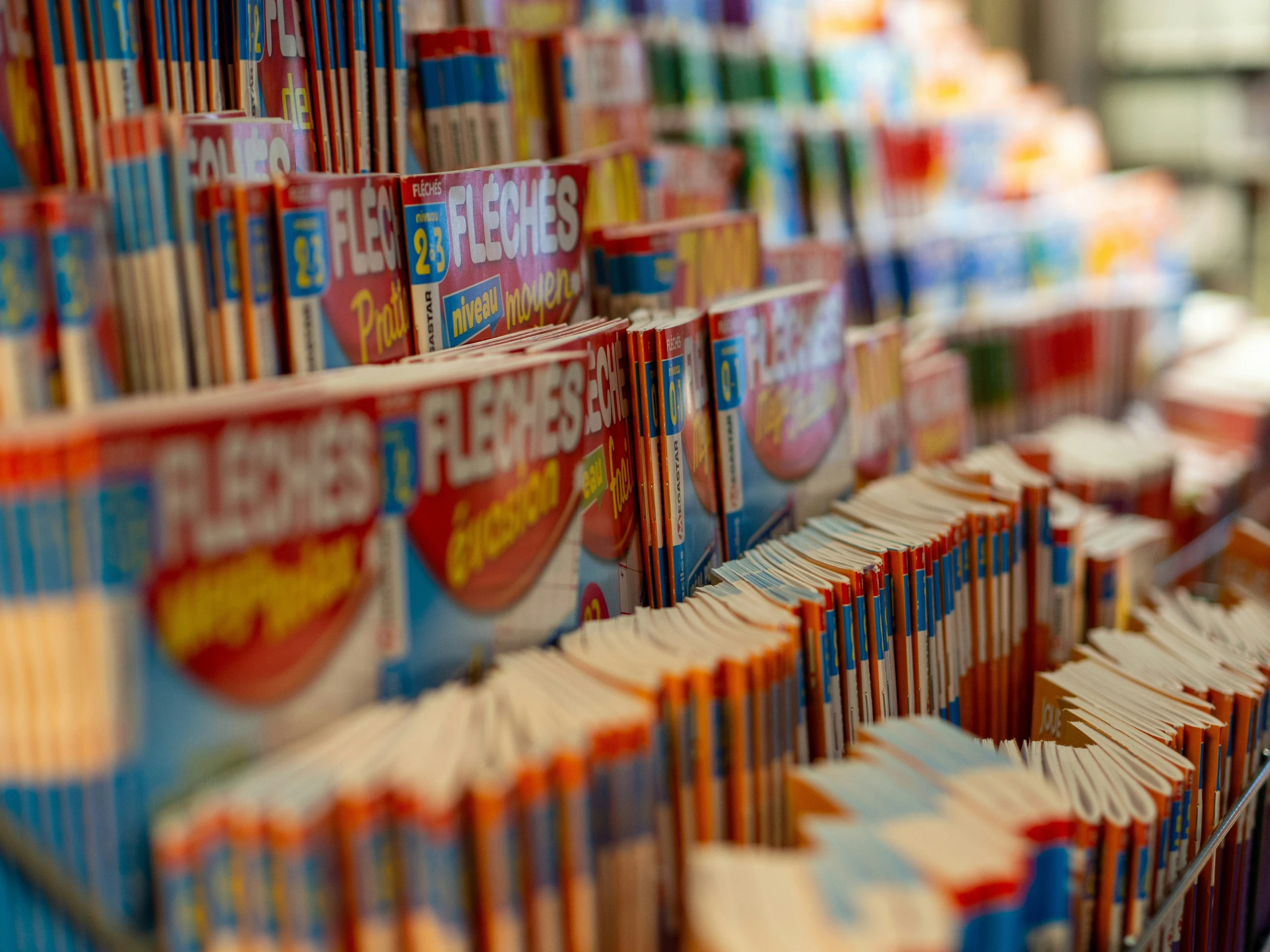 many different kind of books lined up on a shelf