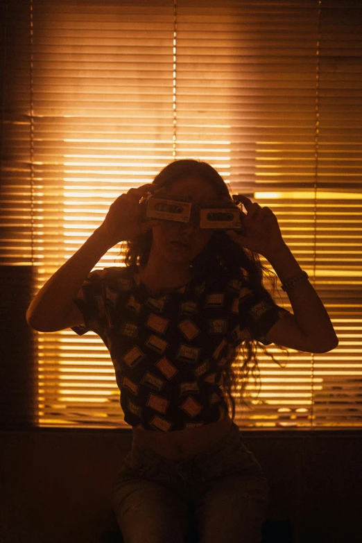 a young woman poses in front of the light coming through the window