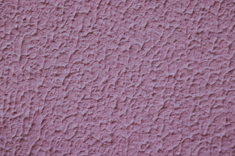 a close up s of the pink textured paint on a wall