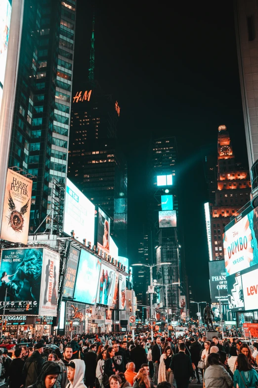 large group of people standing in the street at night