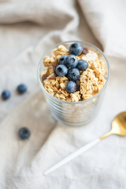 a bowl filled with granola and blueberries