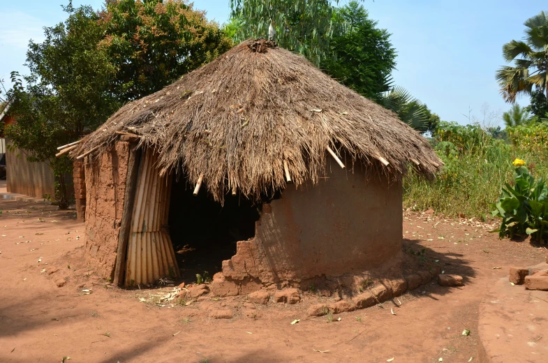 an old village is adorned with a long thatched hut