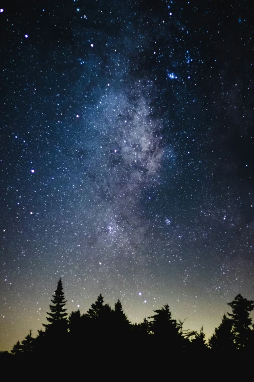 the night sky filled with stars and bright clouds