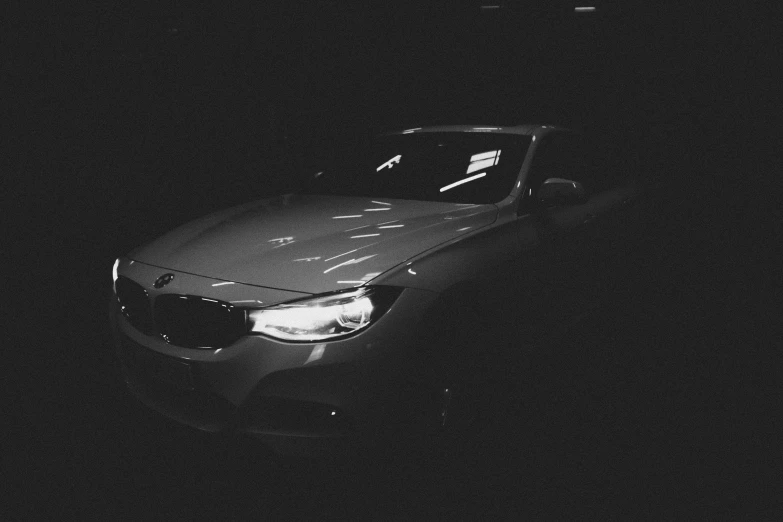 an abandoned car in a dark parking lot