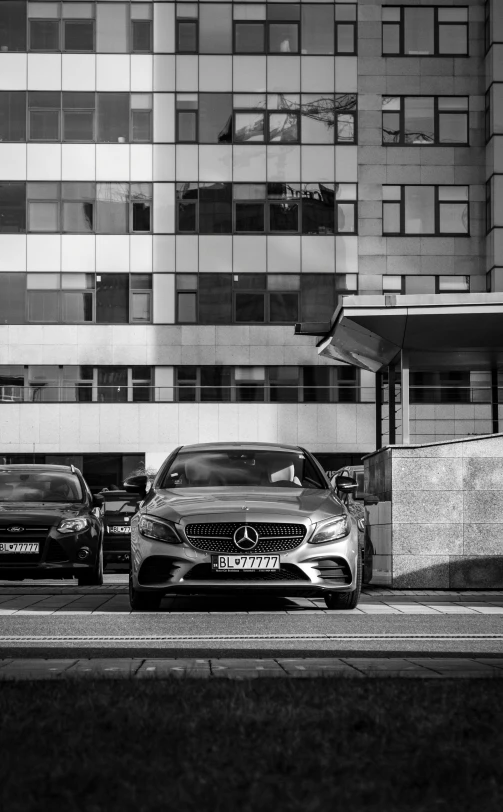 three cars are parked on a city street next to buildings