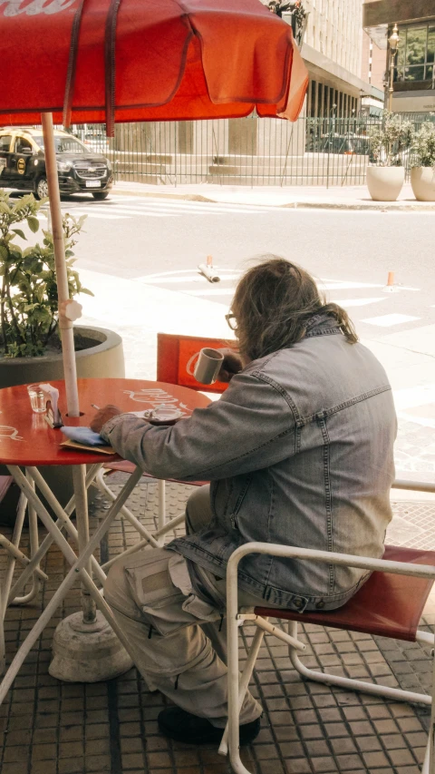 a man sitting at an outside table