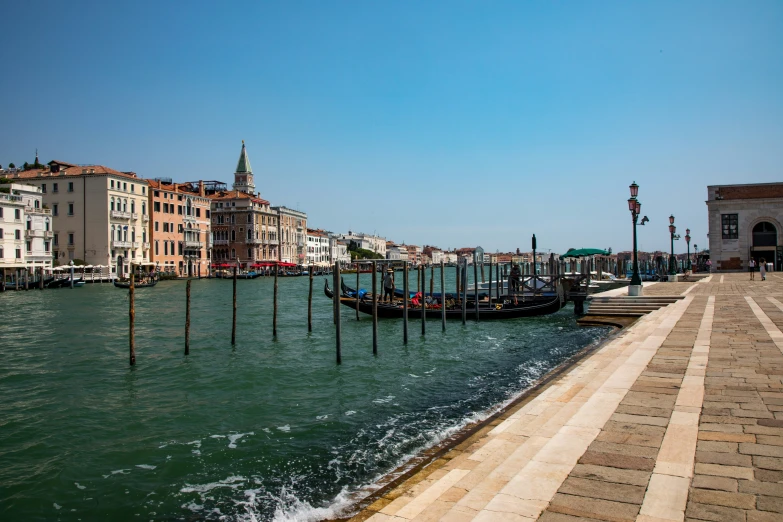 water is in the front of the city with gondola's on each side