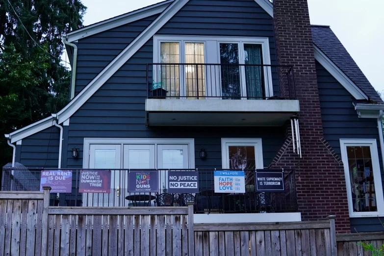 a residential home with many signs in front of it