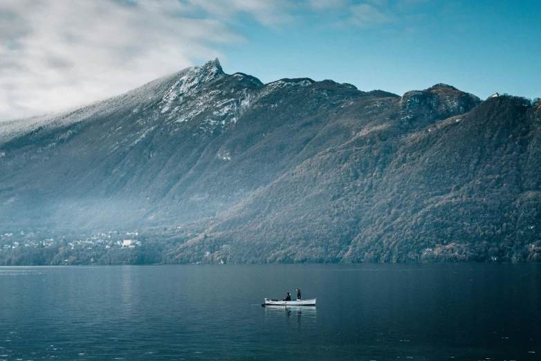 a boat on the water near a mountain range